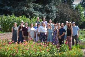Employees of Applewood Seed Company pose together in flower gardens.